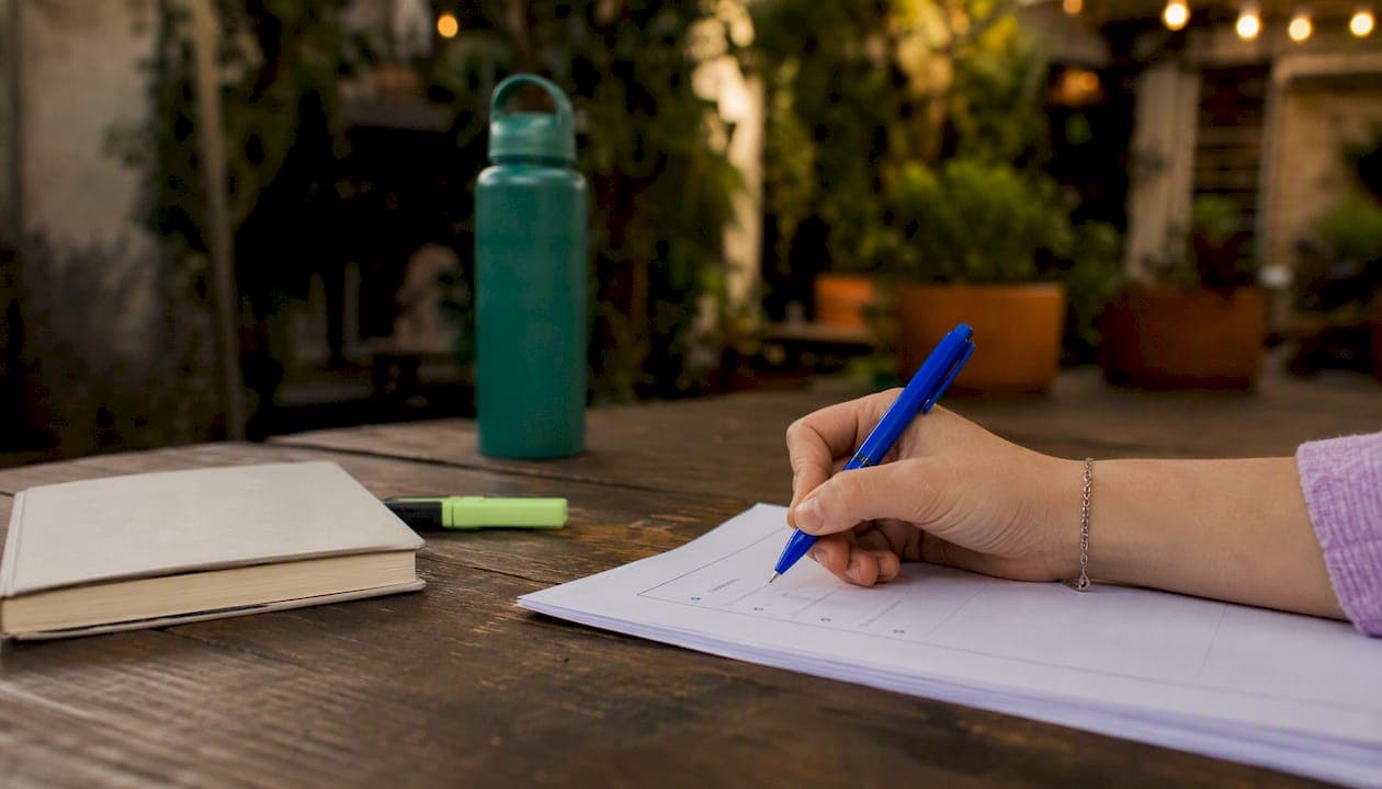 Hand marking essay structure outline on paper